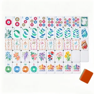 OMHJGO Cranes & Feathers complete mahjong tile set displayed face-up in organized rows showing Dot suit chrysanthemum tiles, Crak calligraphy tiles, Bam feather tiles, NEWS jade disc Wind tiles, botanical Flower tiles, and crown Joker tiles